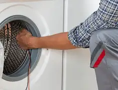 Dryer repair technician diagnosing and servicing a clothes dryer in Tampa, FL