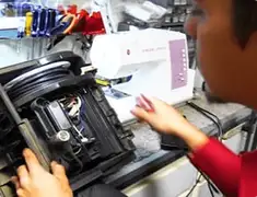 Vacuum repair technician servicing internal components on a workbench in Tampa, FL