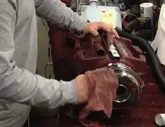 Vacuum repair technician cleaning and servicing a vacuum motor in Tampa, FL