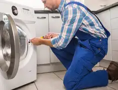 Washing machine repair technician servicing a front-load washer in Tampa, FL