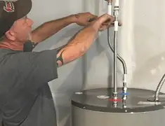 Water heater repair technician tightening supply line connections in Tampa, FL